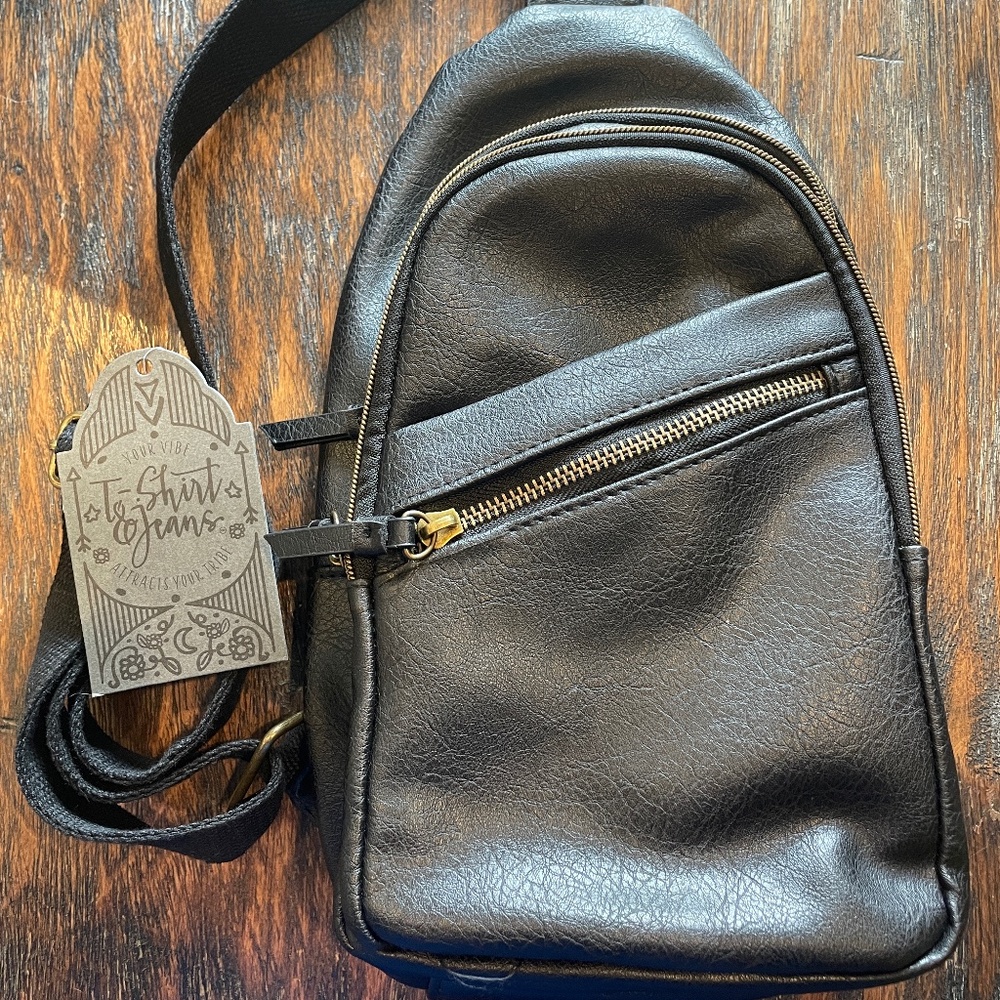 Women's small crossbody black sling bag. Faux black leather.